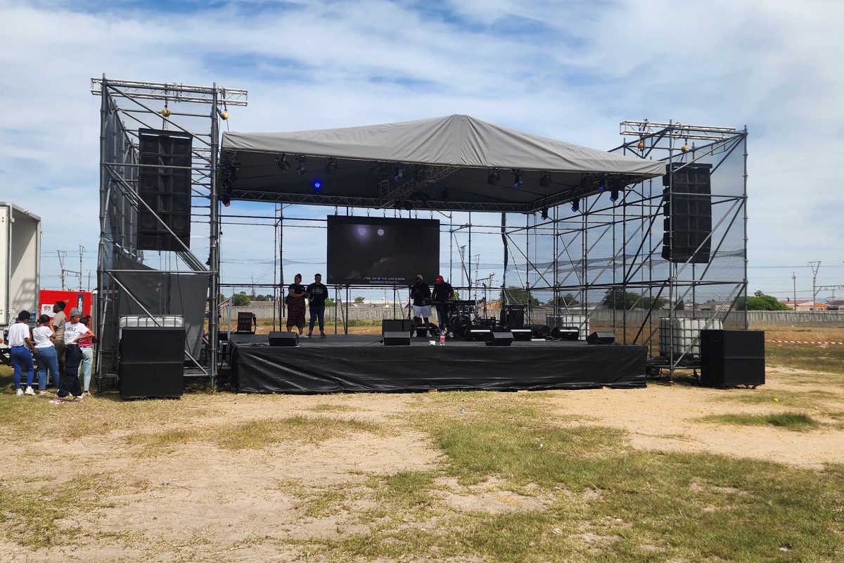 Setting up a performance stage for an outdoor event